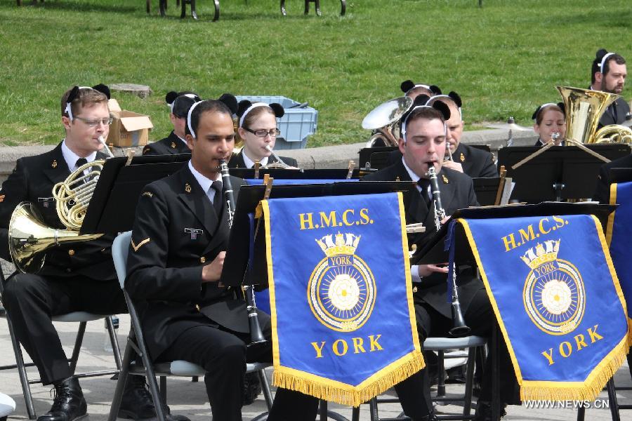 A band from Canada Navy plays at the Toronto Zoo in Toronto, Canada, on May 18, 2013. Er Shun and Da Mao, the two giant pandas on a 10-year loan from China, made their first public appearance in their new home at the Toronto Zoo on Saturday. (Xinhua/Zhang Ziqian) 