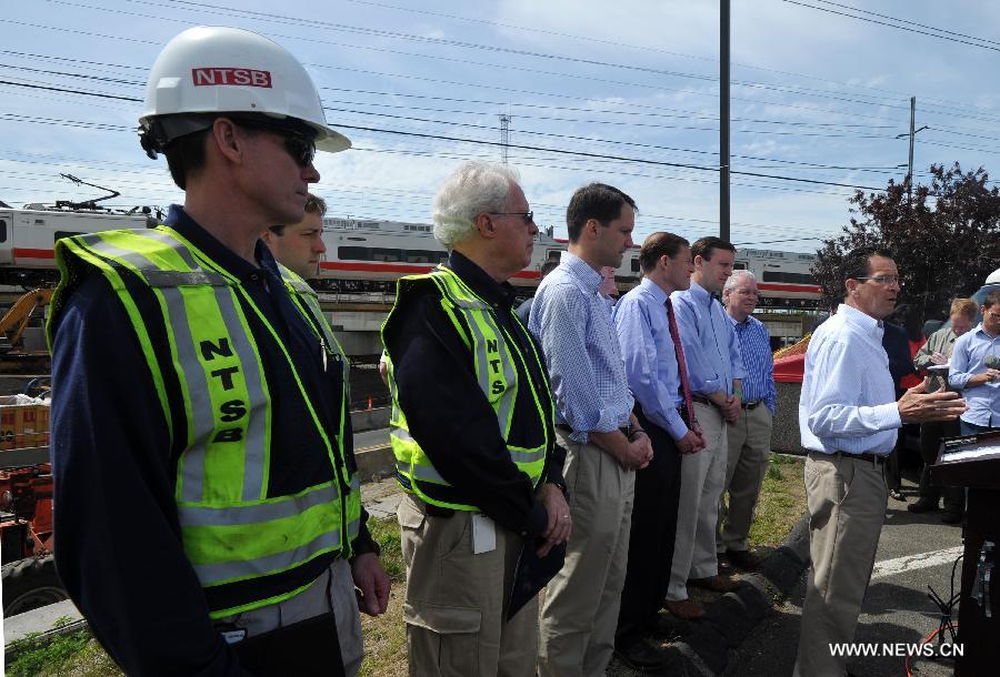 Connecticut Gov. Dan Malloy (1st R) speaks at a press briefing following a Metro North train collision in Fairfield, Connecticut, the United States, on May 18, 2013. Investigators have begun their probe into the commuter train collision which took place in the U.S. state of Connecticut during Friday evening rush hour, leaving more than 70 injuries, government officials said in a press briefing Saturday. (Xinhua/Wang Lei) 