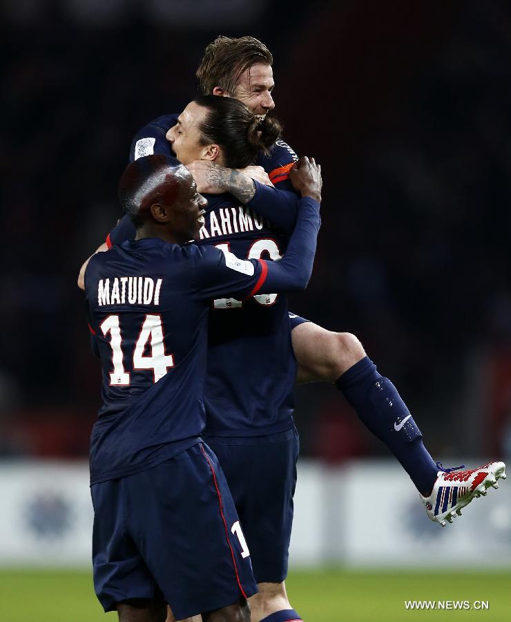 Paris Saint-Germain's English midfielder David Beckham (top) celebrates his teammate Zlatan Ibrahimovic's second goal during French League 1 football match between Paris St Germain and Brest at Parc des Princes stadium in Paris on May 18, 2013.(Xinhua/Wang Lili)