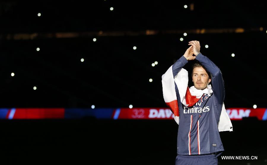 Paris Saint-Germain's English midfielder David Beckham waves to the crowd during the celebration ceremony for winning the French League 1 title after the League 1 football match between Paris St Germain and Brest at Parc des Princes stadium in Paris on May 18, 2013. (Xinhua/Wang Lili)