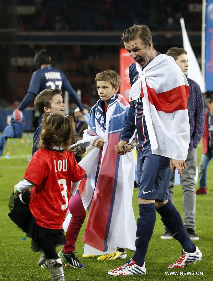 Paris Saint-Germain's English midfielder David Beckham shares a light moment with with his three sons, Brooklyn (R), Romeo (C), Cruz (L) and an unidentified child during the celebration for winning the French League 1 title after the League 1 football match between Paris St Germain and Brest at Parc des Princes stadium in Paris on May 18, 2013. (Xinhua/Wang Lili)