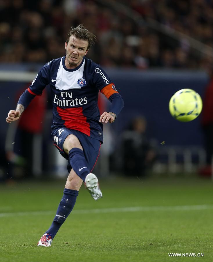 Paris Saint-Germain's English midfielder David Beckham kicks the ball during the French League 1 football match between Paris St Germain and Brest at Parc des Princes stadium in Paris on May 18, 2013. (Xinhua/Wang Lili)