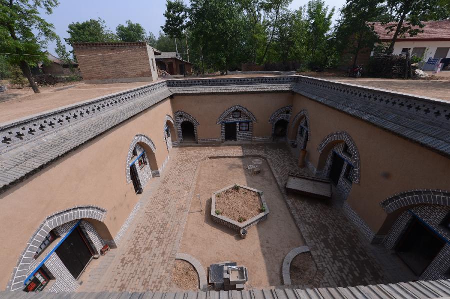 Photo taken on May 18, 2013 shows a renovated sunken courtyard in Qucun Village of Zhangbian Township in Shaanxian County, central China's Henan Province. The sunken courtyard, a kind of traditional residential construction in west Henan, has a high value in the study of local histroy, architecture, geology and sociology. The Qucun Village has 115 sunken courtyards, most of which are under protective reconstruction. (Xinhua/Zhao Peng) 