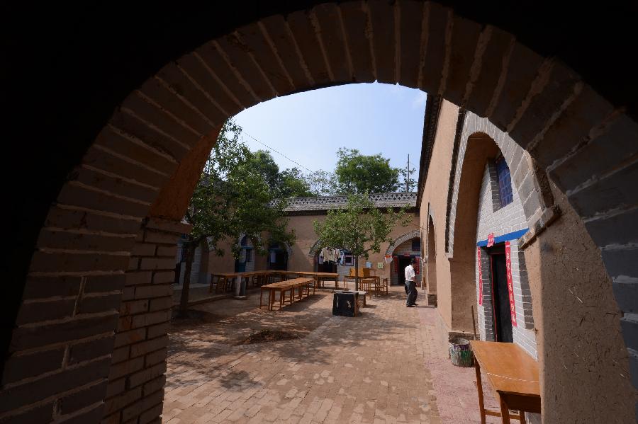 Photo taken on May 18, 2013 shows a renovated sunken courtyard in Qucun Village of Zhangbian Township in Shaanxian County, central China's Henan Province. The sunken courtyard, a kind of traditional residential construction in west Henan, has a high value in the study of local histroy, architecture, geology and sociology. The Qucun Village has 115 sunken courtyards, most of which are under protective reconstruction. (Xinhua/Zhao Peng) 