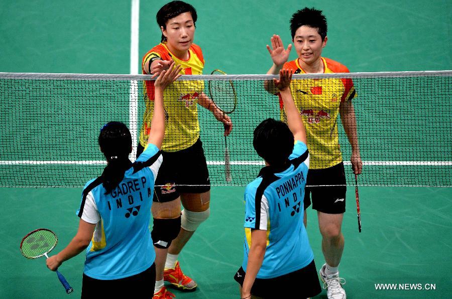 Yu Yang (top R) and Wang Xiaoli (top L) of China greet India's Ashwini Ponnappa (bottom R) and Pradnya Gadre after the 2013 Sudirman Cup world mixed team badminton championship in Kuala Lumpur, Malaysia, on May 19, 2013. The Chinese pair won 2-0. The Chinese team won 5-0 in total. (Xinhua/Chen Xiaowei)