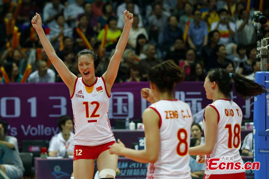 The Chinese women's volleyball team celebrates their victory after beating Puerto Rico in straight sets in Ningbo, Zhejiang Province, May 19, 2013. The Chinese team, which was formed last week, proved a class above their opponents and won the match 25-12, 25-20, 25-14 in just one hour and 11 minutes at the Beilun International Volleyball Tournament.(CNS/Fu Tian)