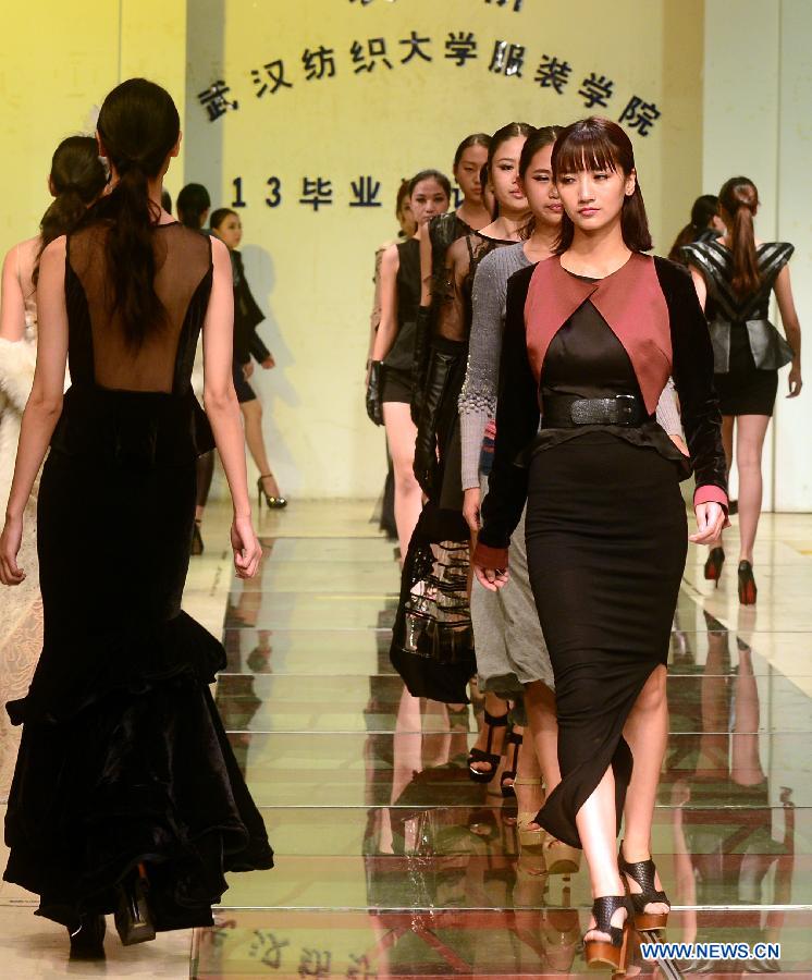 Models present creations designed by graduates of the School of Fashion under the Wuhan Textile University during a fashion show in Wuhan, central China's Hubei Province, May 20, 2013. (Xinhua/Cheng Min)