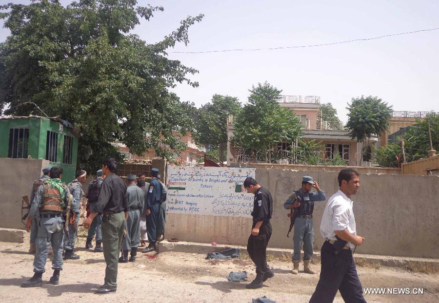 Afghan policemen gather at the site of a suicide bombing in Pul-e-Khumri city, Baghlan province, Afghanistan, May 20, 2013. 14 people, including the head of provincial council, were killed and 13 others wounded Monday morning when a suicide bombing went off near the council office building in Pul-e-Khumi, the capital city of northern Afghan province of Baghlan. (Xinhua/Sahil)