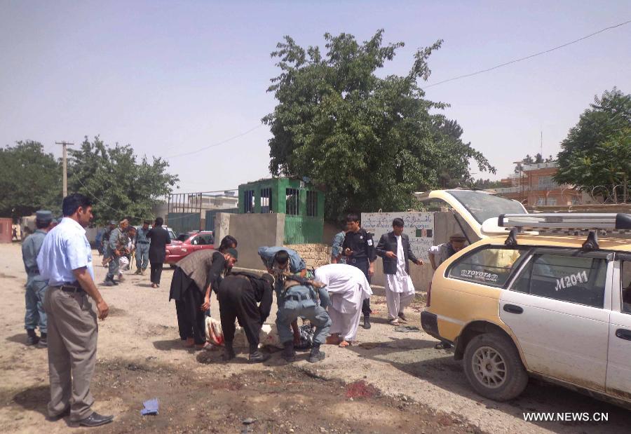 Afghan policemen gather at the site of a suicide bombing in Pul-e-Khumri city, Baghlan province, Afghanistan, May 20, 2013. 14 people, including the head of provincial council, were killed and 13 others wounded Monday morning when a suicide bombing went off near the council office building in Pul-e-Khumi, the capital city of northern Afghan province of Baghlan. (Xinhua/Sahil)