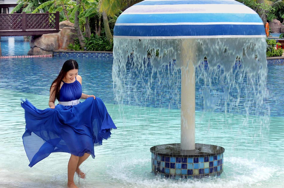 A visitor plays in a thermal spring swimming pool on May 18, 2013 at Guanlan Lake Holiday Resort in Haikou city, Hainan province.  (Photo/Xinhua)