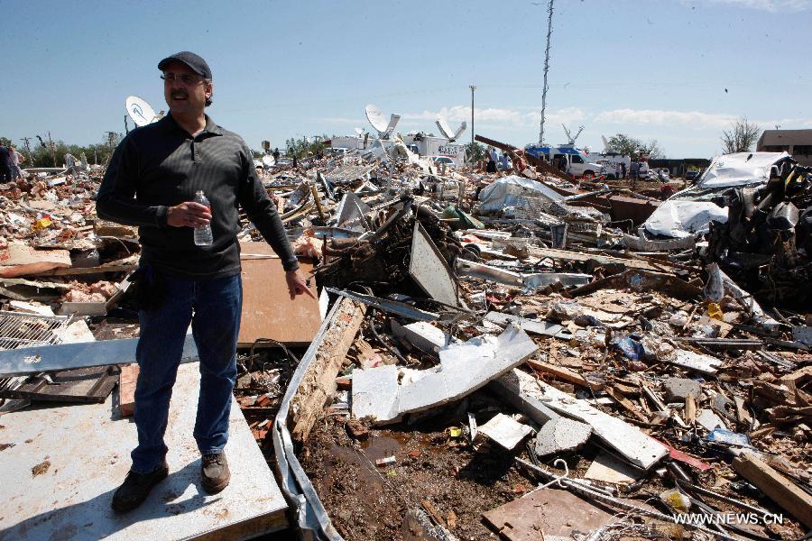 Davis Fress stands among ruins of a tornado-destroyed gas station in Moore, Oklahoma, the United States, May 22, 2013. Twenty-four people were killed and 237 others injured when a massive tornado blasted the southern suburbs of Oklahoma City on Monday. (Xinhua/Song Qiong) 