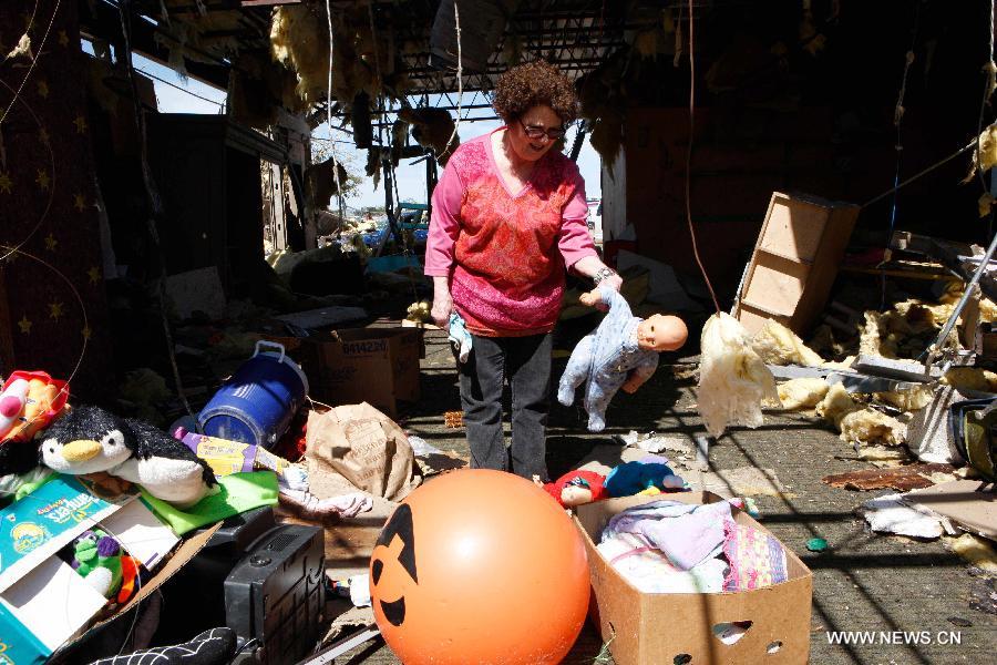 Mrs. Lawrence cleans up a tornado-destroyed preschool in Moore, Oklahoma, the United States, May 22, 2013. Twenty-four people were killed and 237 others injured when a massive tornado blasted the southern suburbs of Oklahoma City on Monday. (Xinhua/Song Qiong) 