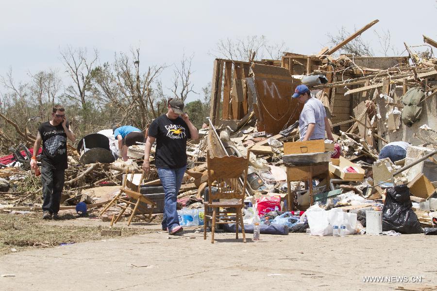 People do cleaning-up work in a tornado-destroyed neighborhood in Moore, Oklahoma, the United States, May 22, 2013. Twenty-four people were killed and 237 others injured when a massive tornado blasted the southern suburbs of Oklahoma City on Monday, state officials said Tuesday. (Xinhua/Marcus DiPaola) 