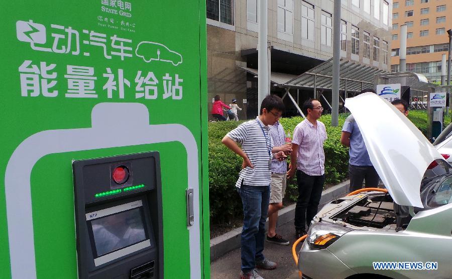 An electric car is getting charged at a rental station in the Tsinghua University Science Park in Beijing, capital of China, May 23, 2013. Fifteen electric cars can be rented at the station. There will be 2,000 electric cars for renting in Beijing by the end of this year. (Xinhua/Li Xin)