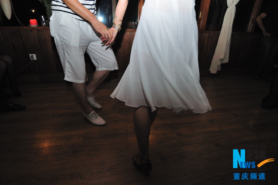 People dance Salsa in a dancing party in Chongqing.