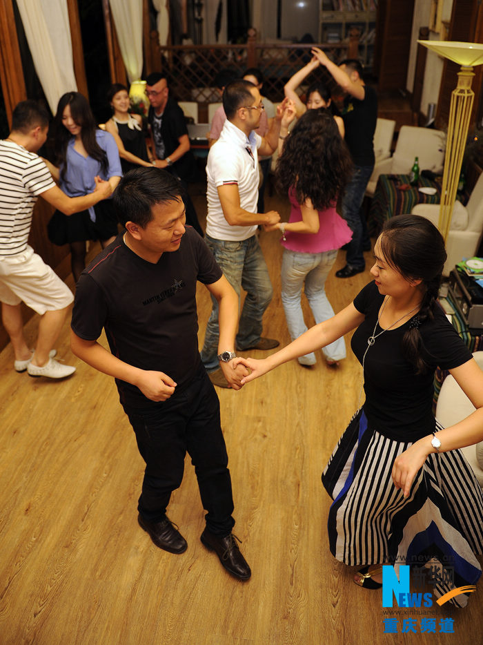 People dance Salsa in a dancing party in Chongqing.