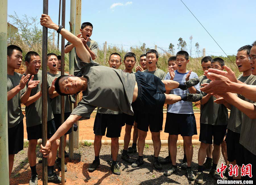 Snipers of the Chinese People's Liberation Army (PLA) participate in military training at a base in Chengdu, Southwest China's Sichuan Province, May 22, 2013. Altogether snipers from over 40 troops of more than 10 corps including the army, navy, air force and the Second Artillery Corps took part in the 40-day training that concluded on Wednesday. [Photo: CNS/Wu Sulin] 