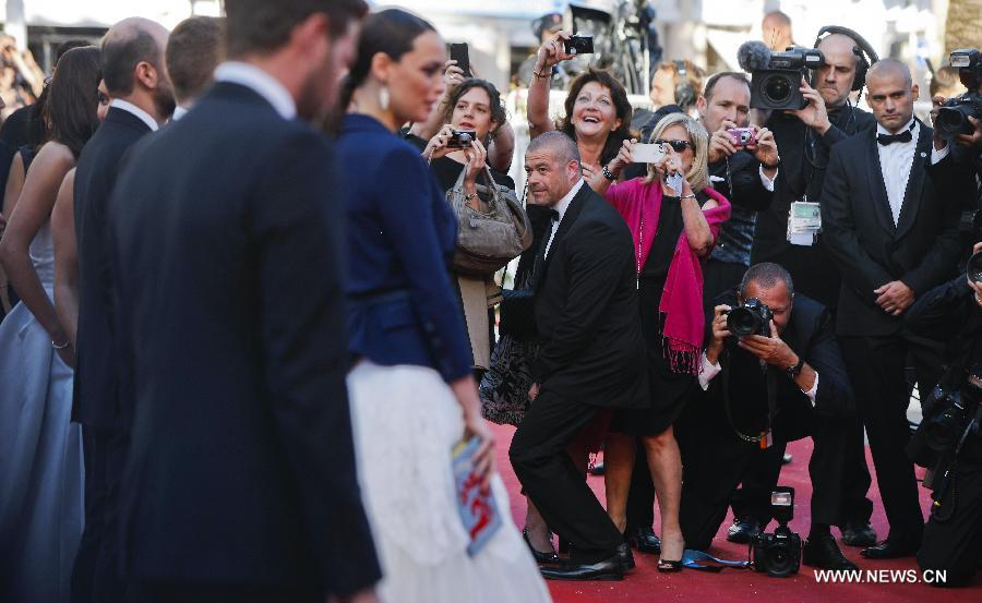 Media staff along with guests invited to the premiere of film in competition take photos of the cast members stepping on the red carpet during the 66th Cannes Film Festival in Cannes, France, on May 17, 2013. The film festival runs from May 15 to May 26 this year. (Xinhua/Zhou Lei) 