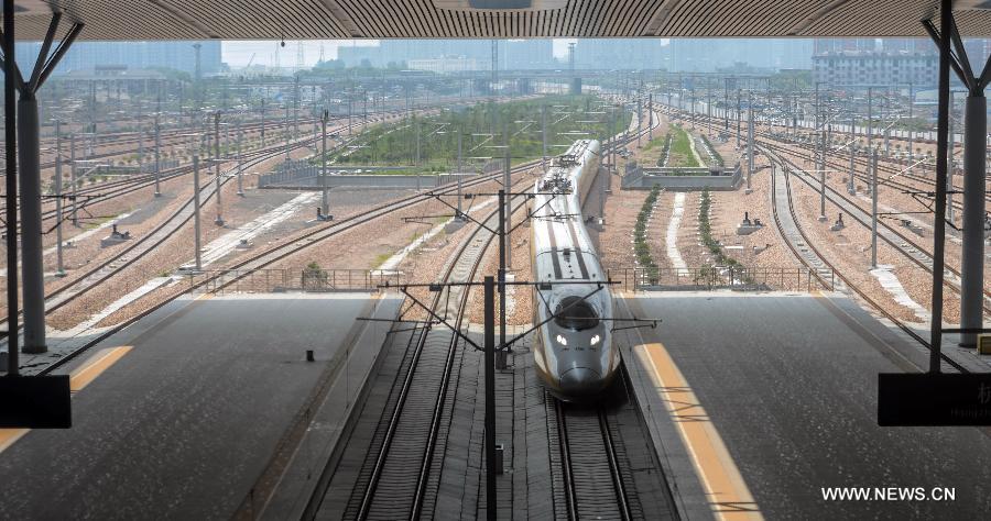 A high-speed train from Ningbo drives into Hangzhou East Station in Hangzhou, capital of east China's Zhejiang Province, May 24, 2013. High-speed rail lines from Nanjing to Hangzhou and Hangzhou to Ningbo began a month-long trial operations on Friday. (Xinhua/Han Chuanhao) 