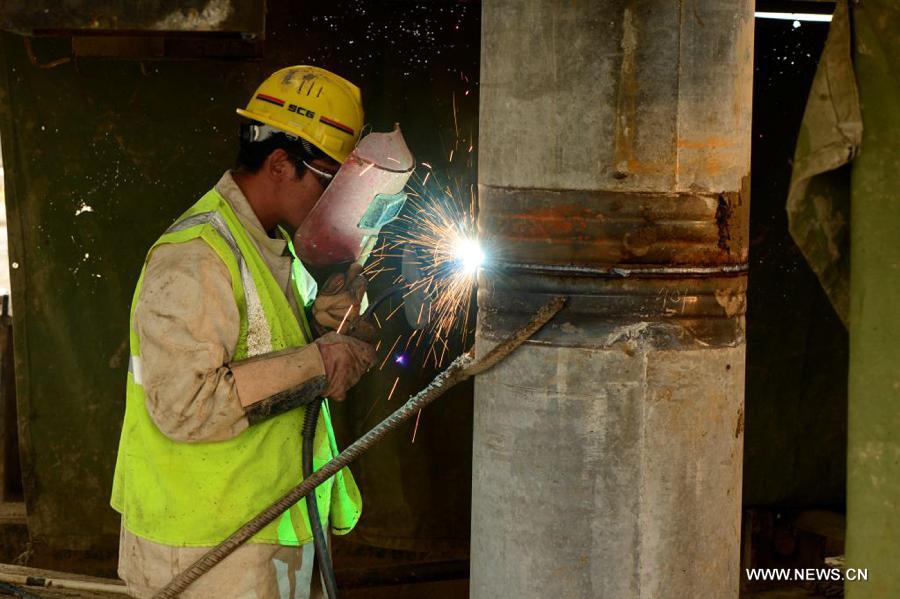 A welder works at the construction site to lay the foundations of a castle at the Shanghai Disney Resort in Shanghai, east China, May 24, 2013. (Xinhua/Ren Long)