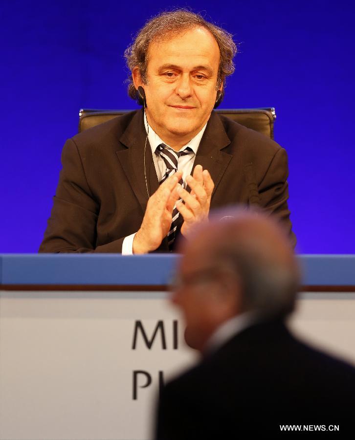 UEFA president Michel Platini (R) greets FIFA president Joseph S. Blatter during the XXXVII Ordinary UEFA Congress 2013 at Grovesnor House Hotel in London, Britain on May 24, 2013. (Xinhua/Wang Lili) 