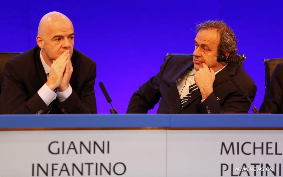 UEFA president Michel Platini (R) and UEFA general secretary Gianni Infantino attend the XXXVII Ordinary UEFA Congress 2013 at Grovesnor House Hotel in London, Britain, on May 24, 2013. (Xinhua/Wang Lili) 