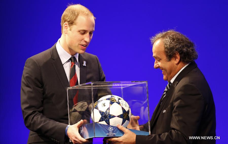 UEFA president Michel Platini (R) presents gifts to Prince William (L), the Duke of Cambridge, during the XXXVII Ordinary UEFA Congress 2013 at Grovesnor House Hotel in London, Britain, on May 24, 2013. (Xinhua/Wang Lili) 