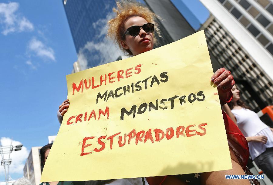 An activist takes part during the "SlutWalk" in Sao Paulo, Brazil, on May 25, 2013. The event was held to protest any form of sexual harassment of any gender in public places among other issues. "SlutWalk" protests originated in Toronto, Canada, where they were sparked by a police officer's remark that women could avoid being raped by not dressing like "sluts". (Xinhua/Rahel Patrasso)