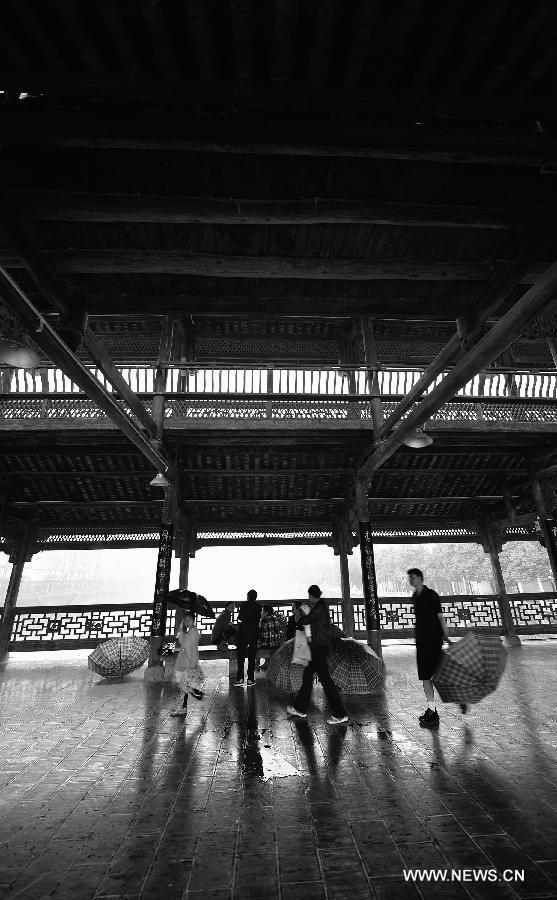 Pedestrians walk on a veranda bridge in Xuan'en County, central China's Hubei Province, May 25, 2013. Veranda bridge is a typical architecture of China's Dong ethnic group in south China. (Xinhua/Song Wen)  