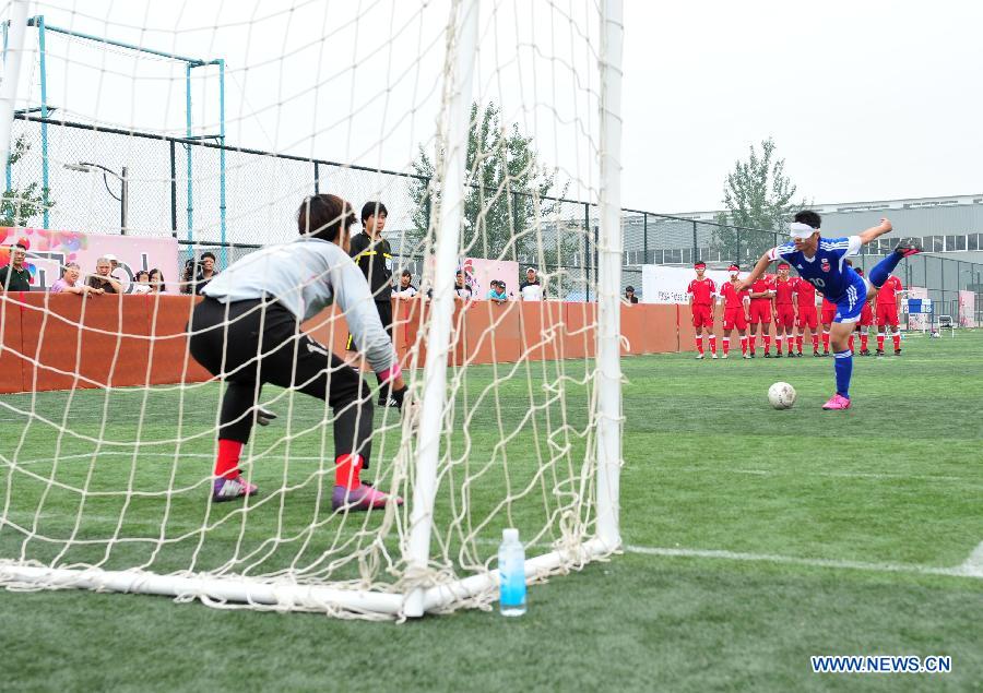 Ochiai Hiroshi (R) of Japan kicks a penalty during the final match of IBSA Futsal B1 Asian Championships against China in Beijing, capital of China on May 26, 2013. China won 3-2 to claim the title. (Xinhua/He Changshan)