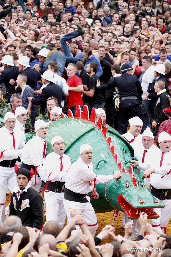 People attend the Ducasse de Mons or Doudou celebration in Mons, Belgium, May 26, 2013. The popular festival, originating in the Middle Ages and depicting the combat between Saint George and a dragon, is recognized by UNESCO as one of the Masterpieces of the Oral and Intangible Heritage of Humanity. (Xinhua/Wang Xiaojun) 