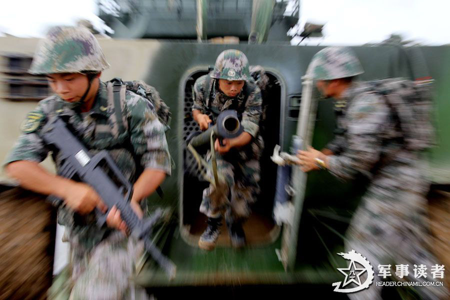 An amphibious armored brigade under the Nanjing Military Area Command (MAC) of the Chinese People's Liberation Army (PLA) takes its troops to unfamiliar area on May 26, 2013 to conduct live-ammunition firing training. (China Military Online/Jiang Jiangao)