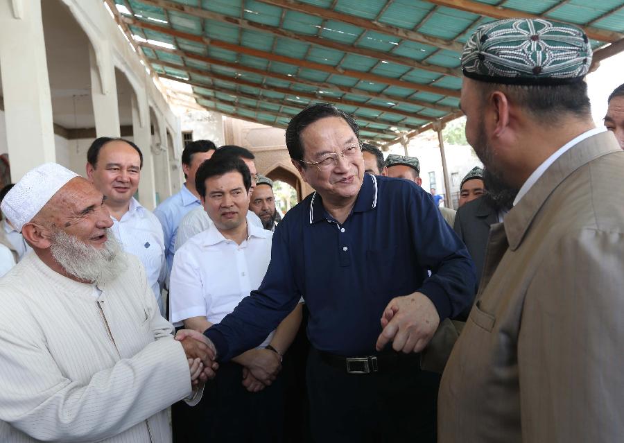 Photo taken on May 23, 2013 shows Yu Zhengsheng (C), a member of the Standing Committee of the Political Bureau of the Communist Party of China (CPC) Central Committee and chairman of the National Committee of the Chinese People's Political Consultative Conference, visits religious people at a mosque in Gulbag of Hotan City, northwest China's Xinjiang Uygur Autonomous Region. Yu paid an inspection tour in Hotan, Kashgar, Yili and Urumqi of Xinjiang from May 23 to 28. (Xinhua/Liu Weibing)