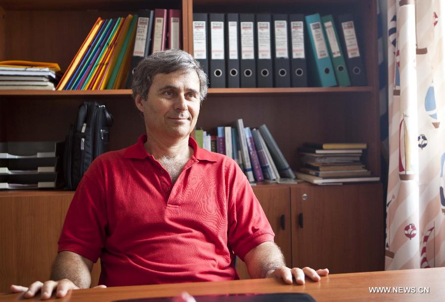 Yiannis Gavalas, a principal of the only school in Iraklia island, Greece, sits in his office on May 22, 2013. For over 20 years, Gavalas has been working in this tiny island covers an area of 18 square kilometers with more than 100 residents. He has recorded about 650 species of plants, 174 species of birds and 26 species of butterflies in his spare time. He has published a book about local butterflies and more will follow. (Xinhua/Liu Yongqiu)