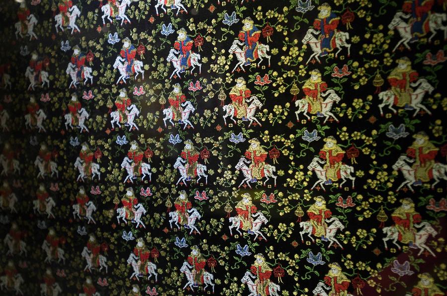 Photo taken on May 27, 2013 shows part of an artwork of Shu brocade, in Chengdu, capital of southwest China's Sichuan Province. Imparted from generation to generation for over 2,000 years, Shu brocade weaving techniques have been put on China's Intangible Cultural Heritage List in 2006. (Xinhua/Li Qiaoqiao) 