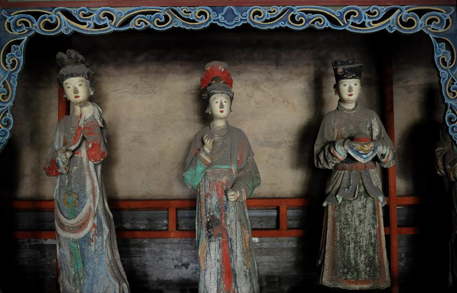 Photo taken on May 24, 2013 shows colored sculptures at the Shengmu Dian (Hall of the Saint Mother) of Jinci Temple in Taiyuan, capital of north China's Shanxi Province. Jinci Temple was first built during the period of the Northern Wei (386-534) in commemoration of Shuyu, the second son of Emperor Wuwang of the Zhou dynasty (1100-771 BC). Shengmu Dian is the principal hall in the temple, built to honor the mother of Shuyu, featuring 42 various sculptures of maids. (Xinhua/Yan Yan) 