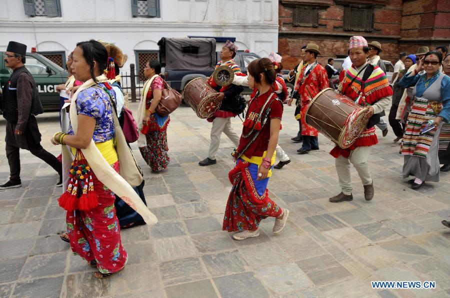 Nepali people in traditional attire participate in the celebrations to mark the Mt. Qomolangma Diamond Jubilee in Kathmandu, Nepal, May 29, 2013. The families of Edmund Hillary and Sherpa Tenzing Norgay are celebrating on Wednesday the 60th anniversary of the first ascent of Mt. Qomolangma in human history when the two heroes reached the summit. (Xinhua/Sunil Pradhan) 