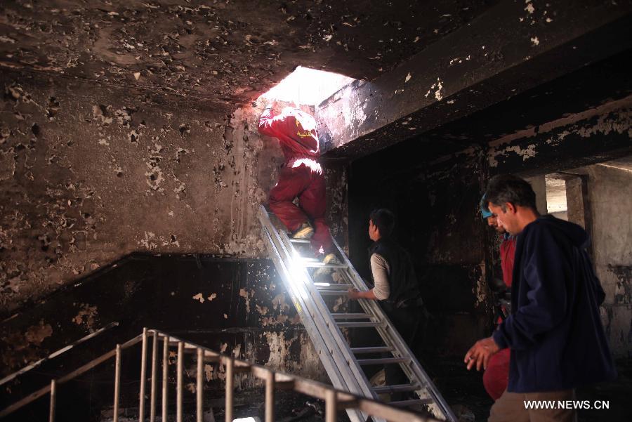 Afghan firemen work at the suicide attack site on Panjshir governor compound in Panjshir province, Afghanistan, on May 29, 2013. One policeman and six militants were killed early Wednesday morning when Taliban suicide bombers launched an attack on the provincial governor office building in eastern Afghan province of Panjshir, a provincial source said. (Xinhua/Ahmad Massoud) 