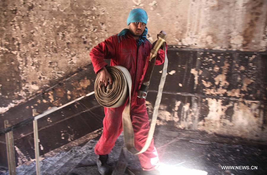 An Afghan fireman works at the suicide attack site on Panjshir governor compound in Panjshir province, Afghanistan, on May 29, 2013. One policeman and six militants were killed early Wednesday morning when Taliban suicide bombers launched an attack on the provincial governor office building in eastern Afghan province of Panjshir, a provincial source said. (Xinhua/Ahmad Massoud) 