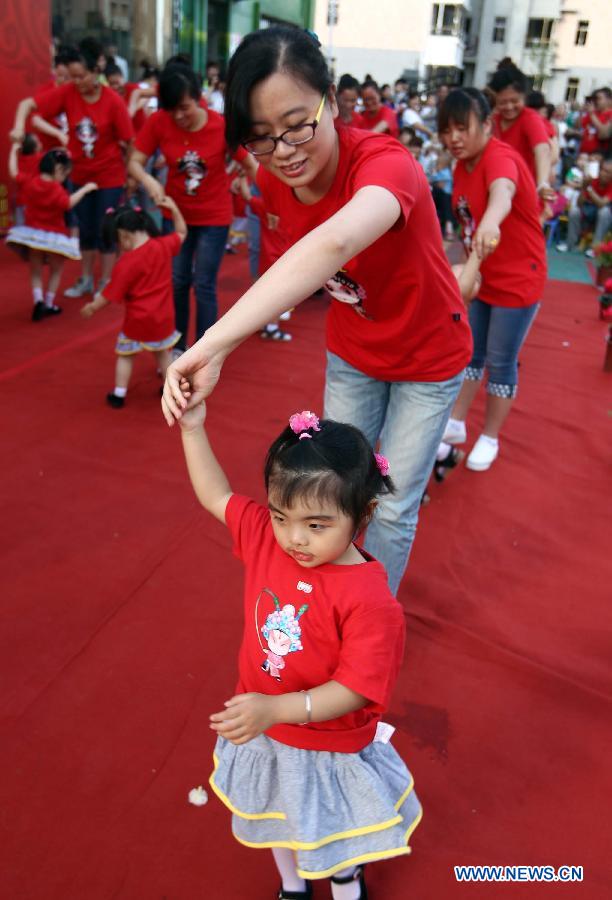 Children dance with their parents at the Dongfang Kindergarten in a celebration for the forthcoming International Children's Day in Yuncheng City, north China's Shanxi Province, May 29, 2013. (Xinhua/Xue Jun)