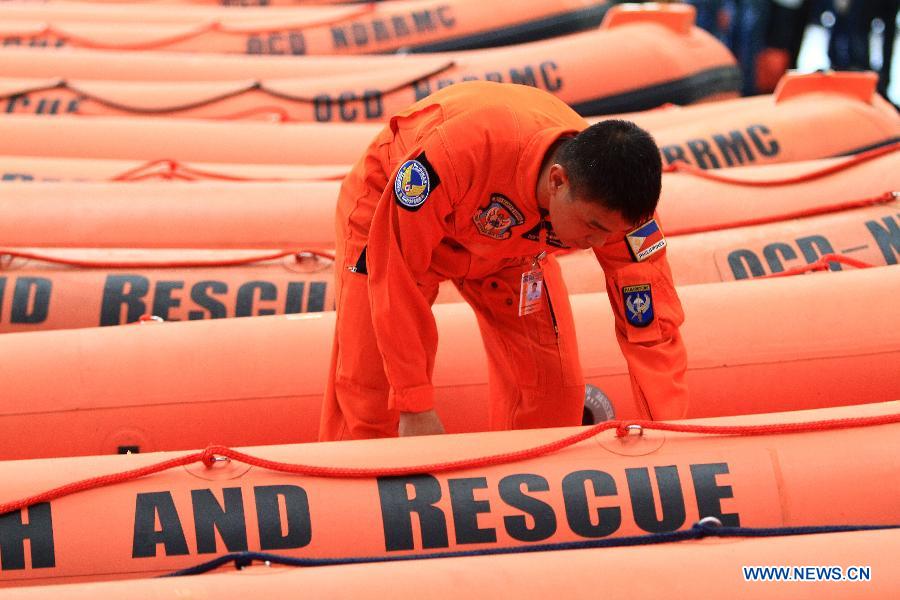 A member of provincial rescue personnel prepares the rigid hull inflatable boats in Camp Aguinaldo in Quezon City, the Philippines, May 30, 2013. The Philippine National Disaster Risk Reduction and Management Council distributed multiple rigid hull inflatable boats and other rescue equipments to flood and disaster-prone provinces in preparation for typhoons. (Xinhua/Rouelle Umali)