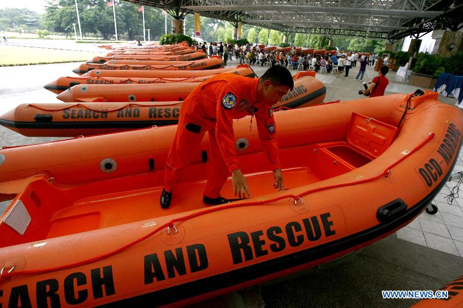 A member of provincial rescue personnel prepares the rigid hull inflatable boats in Camp Aguinaldo in Quezon City, the Philippines, May 30, 2013. The Philippine National Disaster Risk Reduction and Management Council distributed multiple rigid hull inflatable boats and other rescue equipments to flood and disaster-prone provinces in preparation for typhoons. (Xinhua/Rouelle Umali)