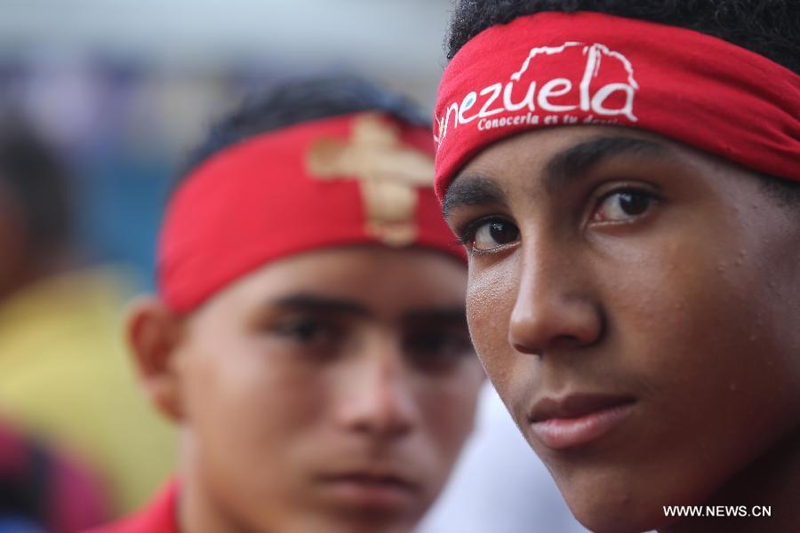 Dancers called "Diablos" of Yare, visit town's shrines on the frame work of Corpus Christi celebrations, at San Francisco de Yare population, in Miranda State, Venezuela, on May 29, 2013. The dancing diablos of Yare pay promises dancing with devil suits, making sound with percussions, along Yare streets. On December 6, 2012, these dancers were declared Humanity's Cultural Intangible Heritage by United Nations for Education, Science and Culture Organization (UNESCO). (Xinhua/Juan Carlos Hernandez)