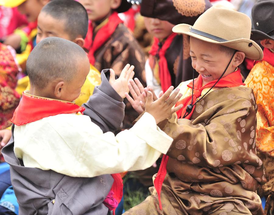 Children play at an activity center in Lhasa, capital of southwest China's Tibet Autonomous Region, May 30, 2013. Various activities are held across China to celebrate the coming International Children's Day. (Xinhua/Liu Kun) 