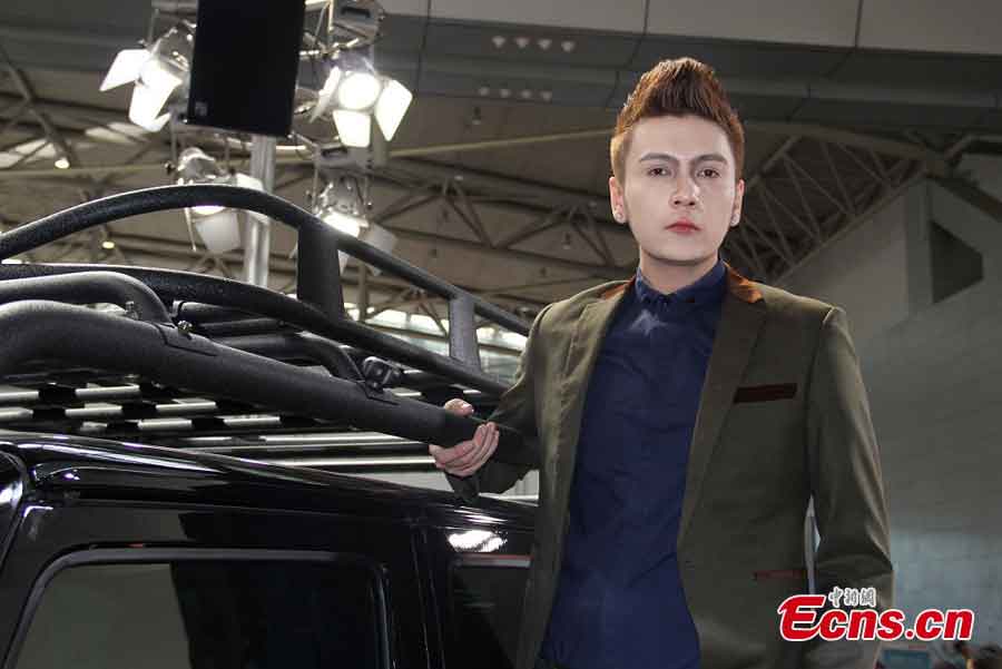 A model presents a car at the 2013 Asia-Europe International Auto Show at the International Exhibition Center in Urumqi, capital of Northwest China's Xinjiang Uygur Autonomous Region, May 29, 2013. (CNS/Yang Zhe)