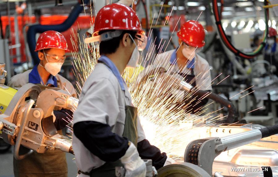 Photo taken on Nov. 24, 2011 shows workers work at a welding workshop in the production base of FAW-Volkswagen at Chengdu, capital of southwest China's Sichuan Province. By the end of 2012, Chengdu's GDP has reached 800 billion RMB (about 130.48 billion U.S. dollars), ranking the 3rd place in China's sub-provincial cities. By May of 2013, more than 230 enterprises in the Fortune 500 have come to Chengdu. The 2013 Fortune Global Forum will be held in Chengdu from June 6 to June 8. Chengdu, an ancient city with a history of over 2,300 year, is developing into an international metropolis with its huge economic development potential as well as its special cultural environment. (Xinhua/Jiang Hongjing)