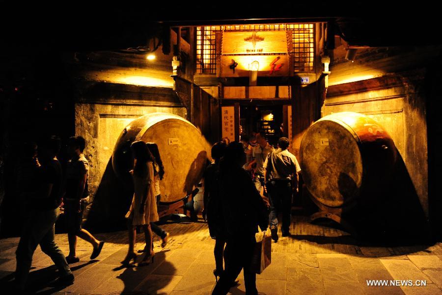 Tourists go sightseeing on the Kuan Zhai Xiang Zi, or the Wide and Narrow Alleys in Chengdu, capital of southwest China's Sichuan Province, May 31, 2013. Consisting of three remodeled historical community alleyways dating back to the Qing Dynasty, the Wide and Narrow Alleys are now bordered with exquisitely decorated tea houses, cafes, boutiques and bookshops. The 2013 Fortune Global Forum will be held in Chengdu from June 6 to June 8. Chengdu, a city known for its slow living pace, is developing into an international metropolis with its huge economic development potential as well as its special cultural environment. (Xinhua/Li Hualiang)