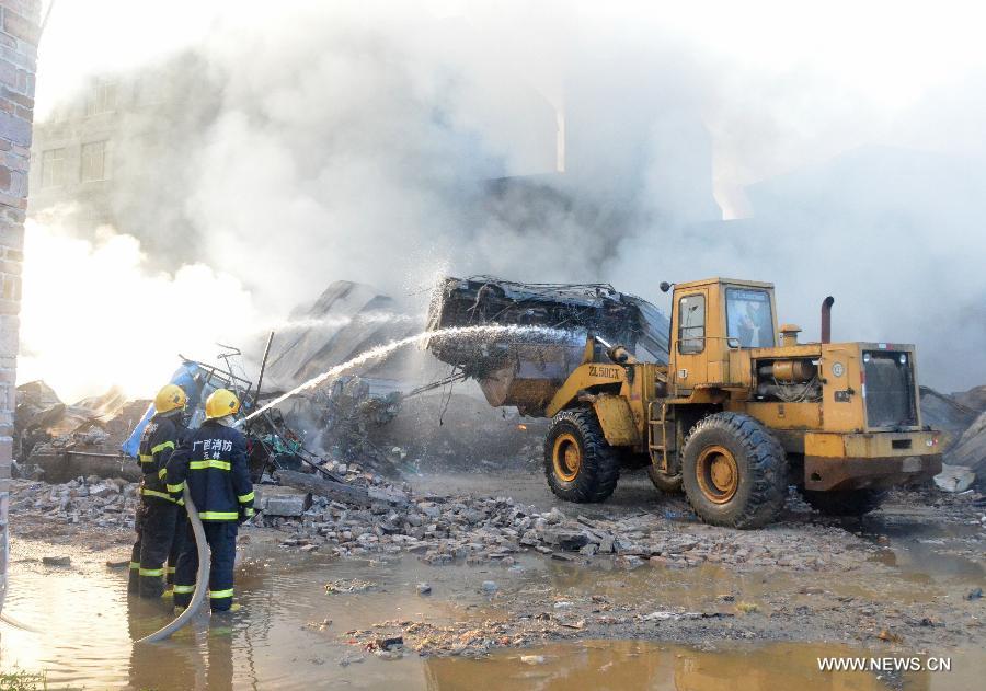 Firemen spray water at the scene of a fire at Daxin Village in Yulin City, south China's Guangxi Zhuang Autonomous Region, early June 2, 2013. The fire broke out at a storehouse early Sunday and was put out after hours by local fire department. The fire burned an area of some 3,000 square meters, with no casualties reported. (Xinhua/Wei Gongbing)