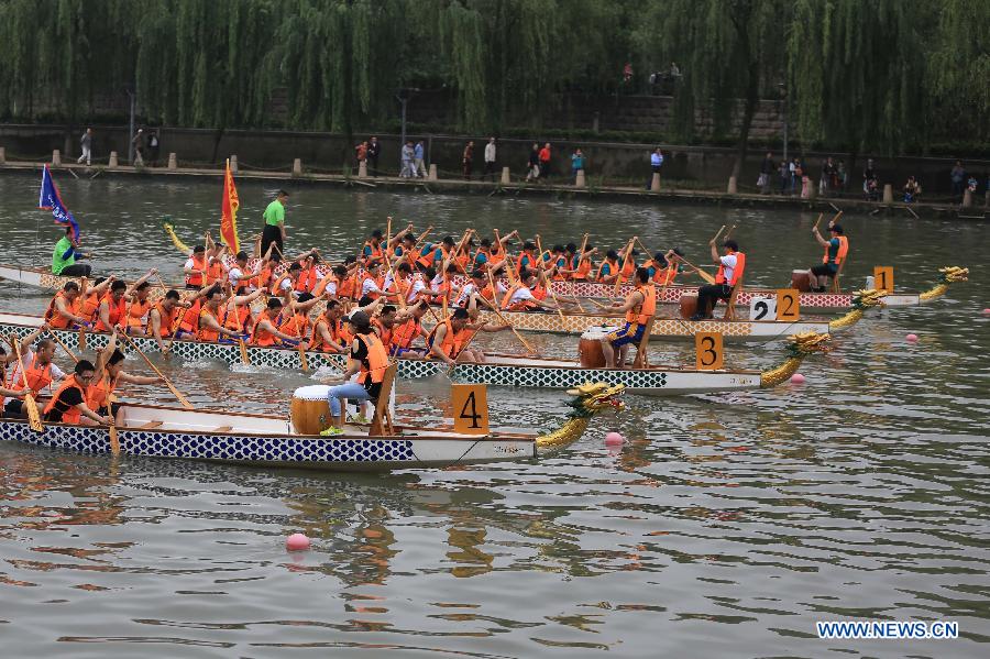 Participants compete in a dragon boat race during a dragon boat carnival on the Qinhuai River in Nanjing, capital of east China's Jiangsu Province, June 2, 2013. The event was held as a means to celebrate the upcoming Dragon Boat Festival, or Duanwu Festival, which falls on the fifth day of the fifth month in the Chinese lunar calendar, or June 12 this year. (Xinhua/Han Hua)