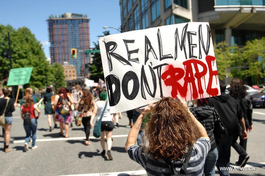 Participants march during a 2013 SlutWalk rally against sexual discrimination or inequality in Vancouver, Canada, on June 2, 2013. Slutwalk is a movement across the world, calling for equal rights for sex and genders' respect, which was provoked after a policeman advised young women to "avoid dressing like sluts" in Canada in April 2011. (Xinhua/Sergei Bachlakov) 